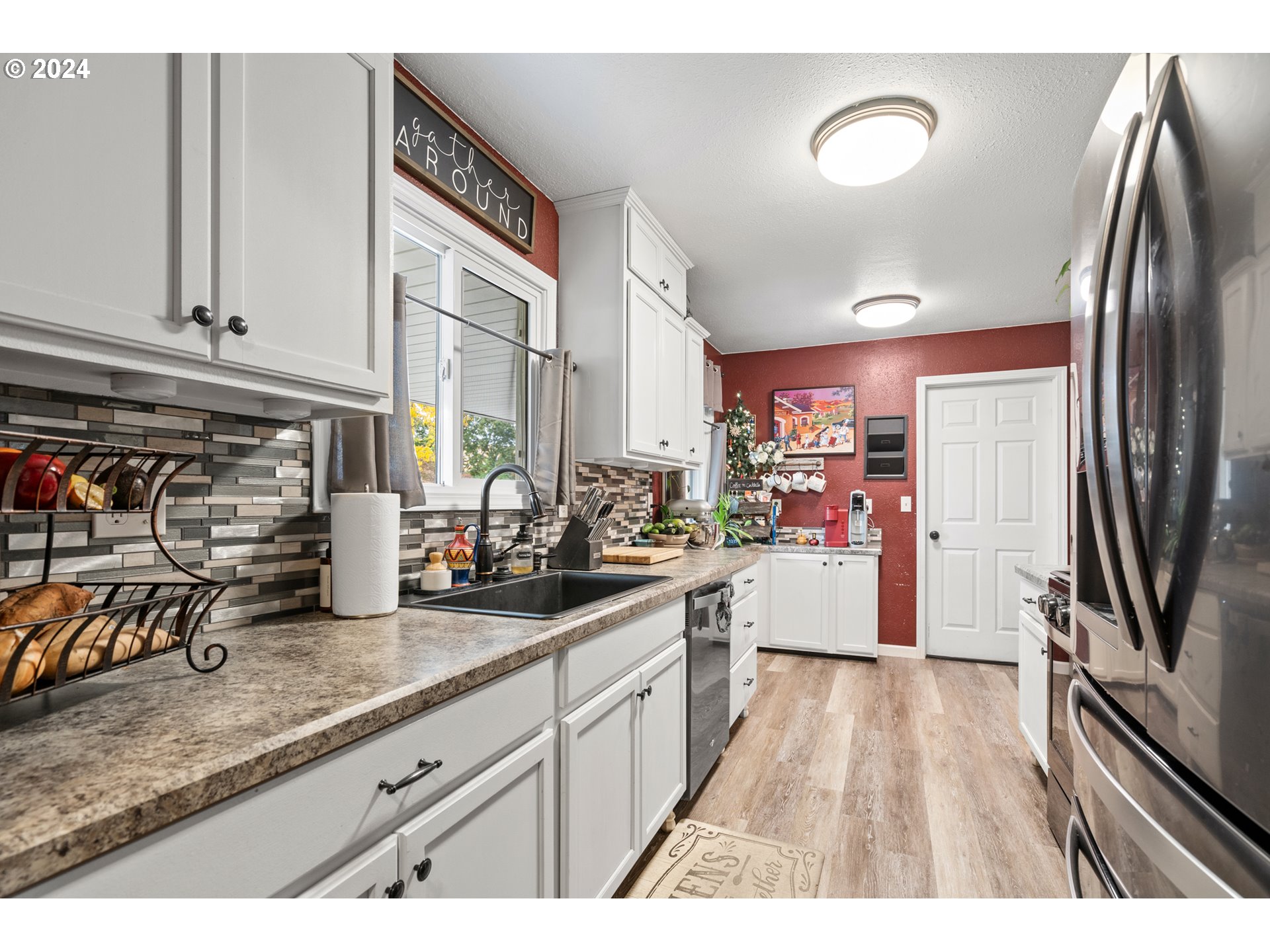 1338 Southwest 41st Street Pendleton, OR 97801 - Photo 8 of 40 a kitchen with granite countertop a refrigerator a sink a stove and cabinets