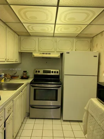 a kitchen with a sink cabinets and stainless steel appliances
