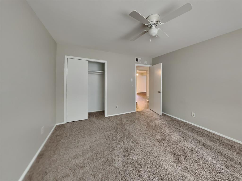 647 Rutgers Drive Lancaster, TX 75134 - Photo 11 of 23 an empty room with a ceiling fan and a window