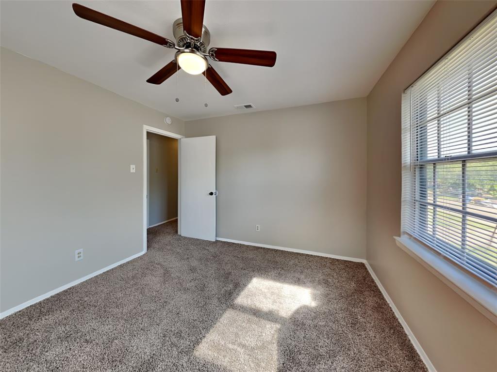 647 Rutgers Drive Lancaster, TX 75134 - Photo 13 of 23 an empty room with windows and fan