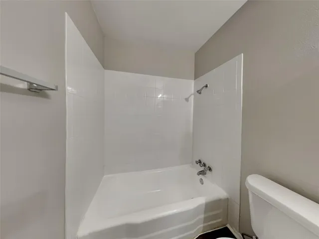 a bathroom with a bathtub and toilet