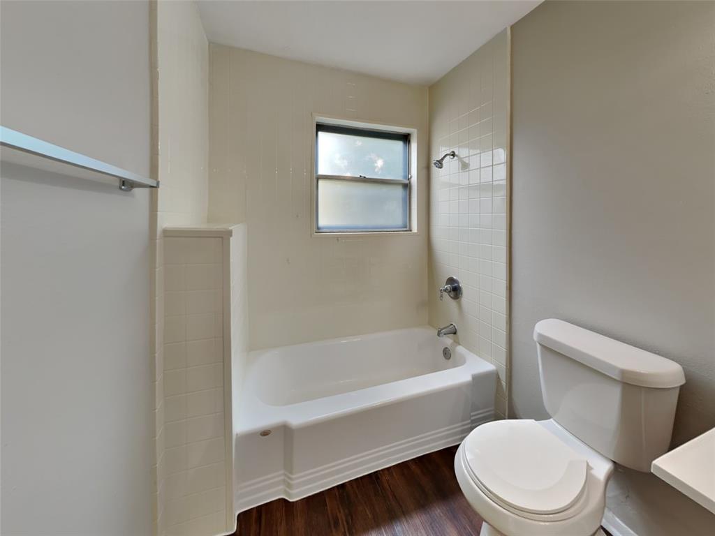 647 Rutgers Drive Lancaster, TX 75134 - Photo 19 of 23 a white toilet and tub sitting next to a bathroom sink