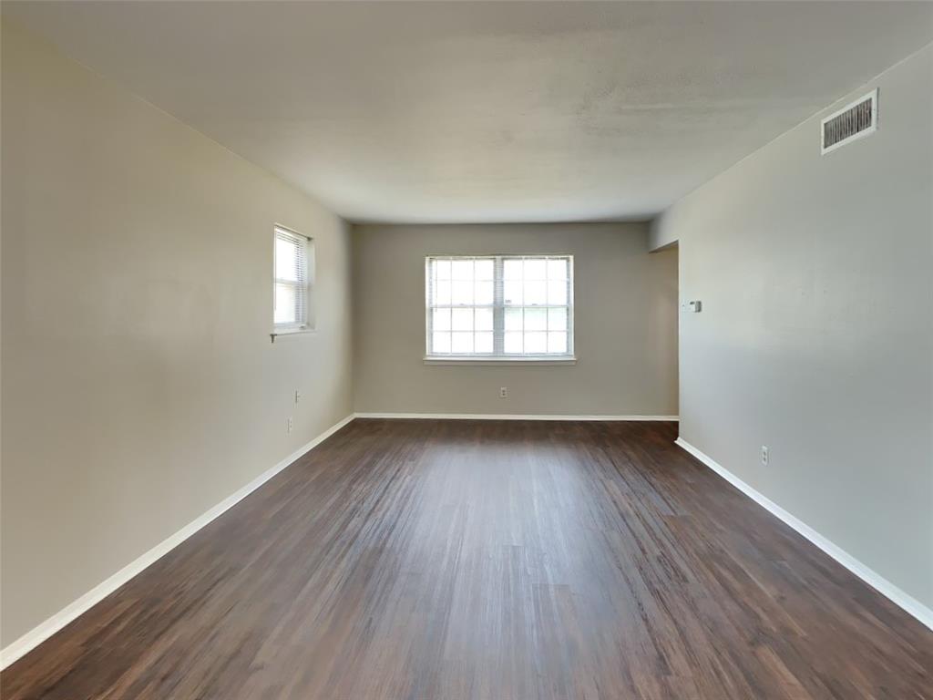 647 Rutgers Drive Lancaster, TX 75134 - Photo 2 of 23 an empty room with wooden floor and windows
