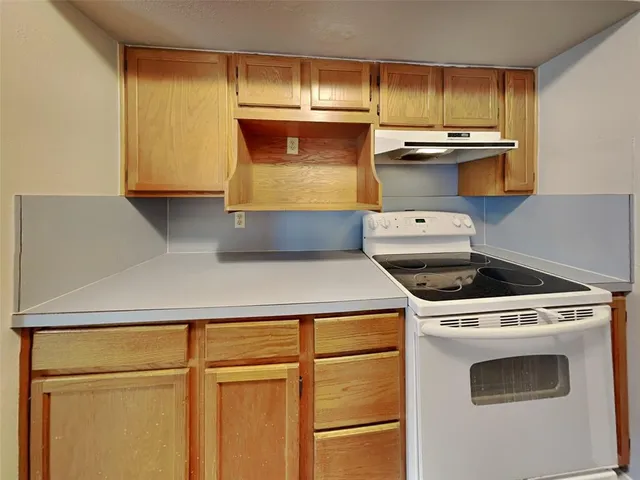 a kitchen with a stove and a refrigerator