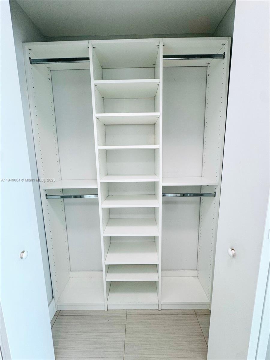 92 Southwest 3rd Street, Unit 3608 Miami, FL 33130 - Photo 12 of 24 a view of walk in closet with empty racks