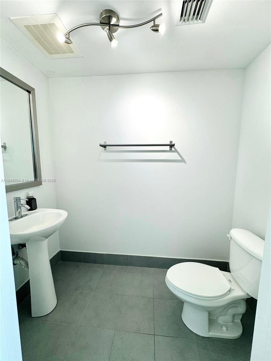 92 Southwest 3rd Street, Unit 3608 Miami, FL 33130 - Photo 15 of 24 a white toilet sitting next to a white sink