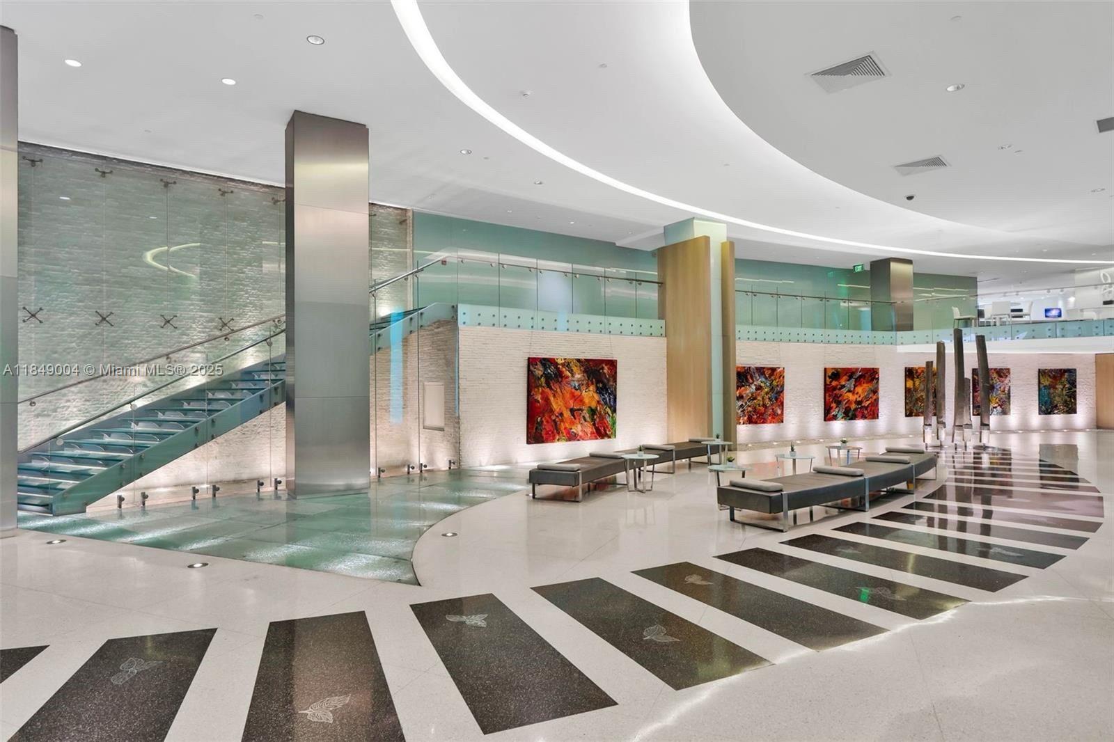 92 Southwest 3rd Street, Unit 3608 Miami, FL 33130 - Photo 22 of 24 a kitchen with stainless steel appliances kitchen island granite countertop a refrigerator and a stove