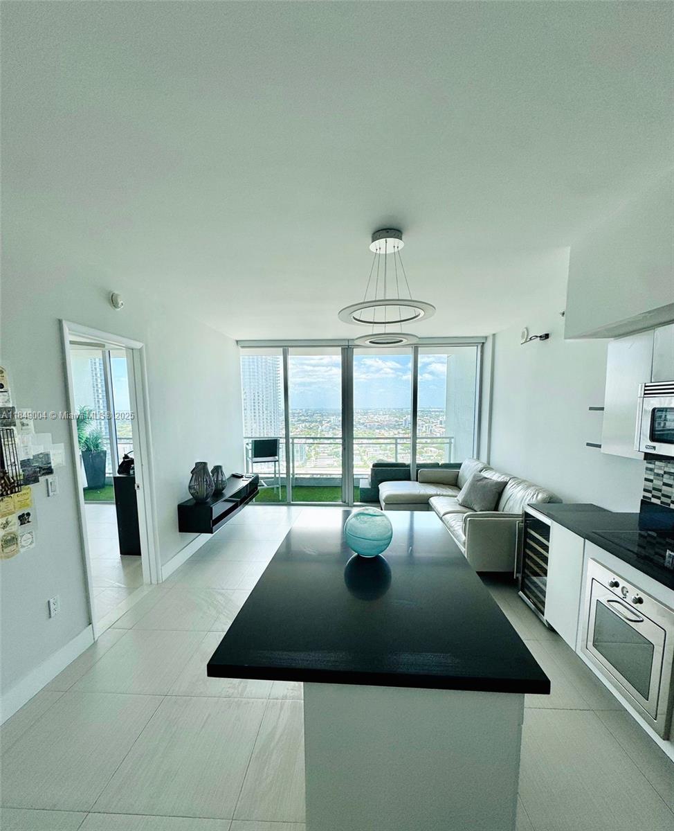 92 Southwest 3rd Street, Unit 3608 Miami, FL 33130 - Photo 6 of 24 a kitchen with a table chairs and a stove