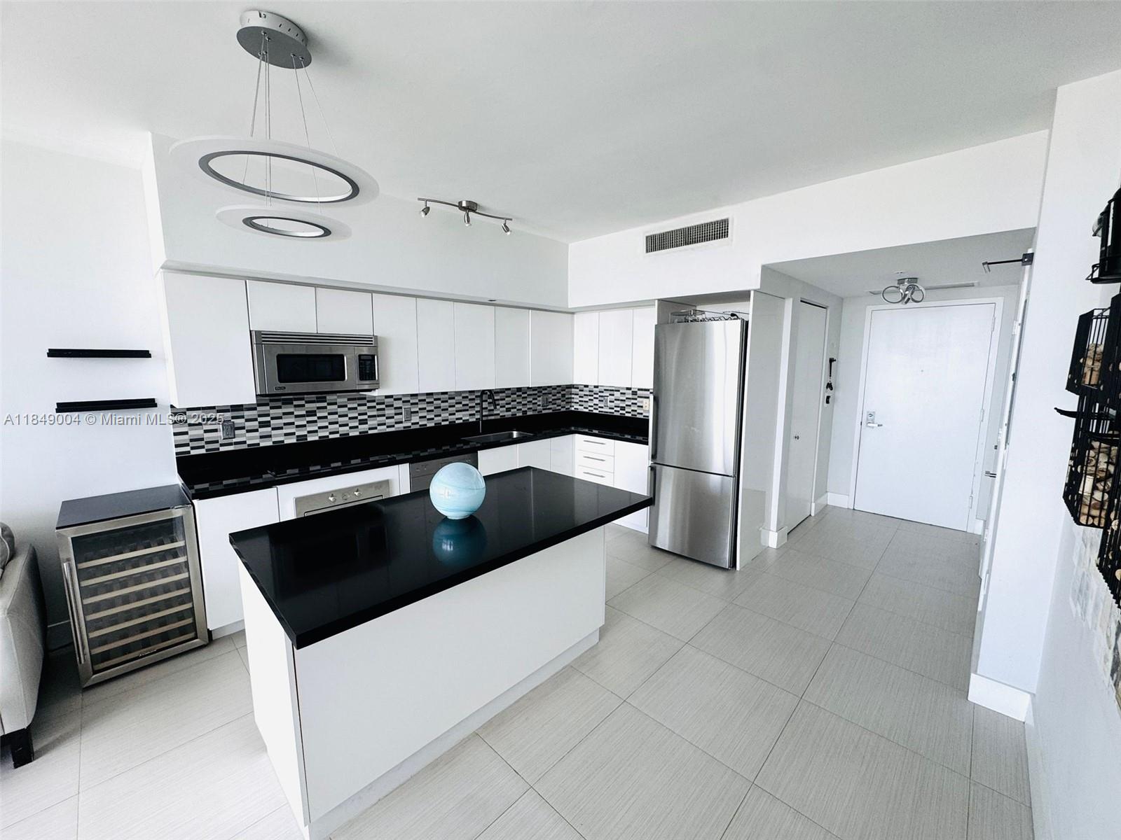 92 Southwest 3rd Street, Unit 3608 Miami, FL 33130 - Photo 7 of 24 a kitchen with granite countertop a sink and a stove