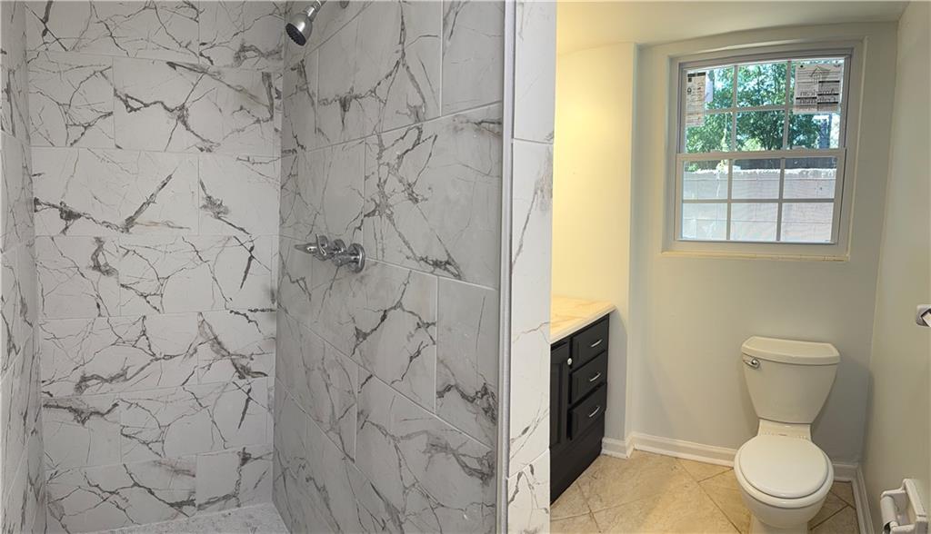 1309 Weston Drive Decatur, GA 30032 - Photo 13 of 35 a white toilet sitting next to a shower curtain