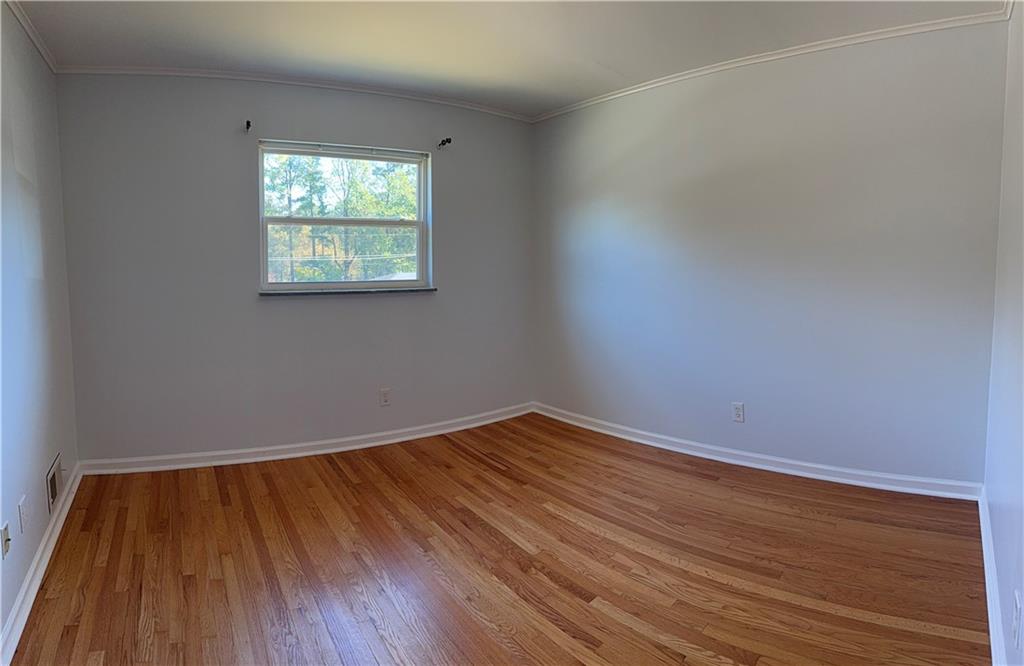 1309 Weston Drive Decatur, GA 30032 - Photo 19 of 35 a view of an empty room with wooden floor and a window