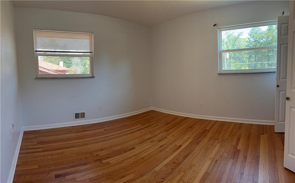 1309 Weston Drive Decatur, GA 30032 - Photo 21 of 35 a room with a wooden floor and a window