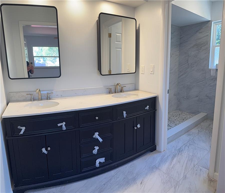 1309 Weston Drive Decatur, GA 30032 - Photo 23 of 35 a bathroom with a double vanity sink and mirror