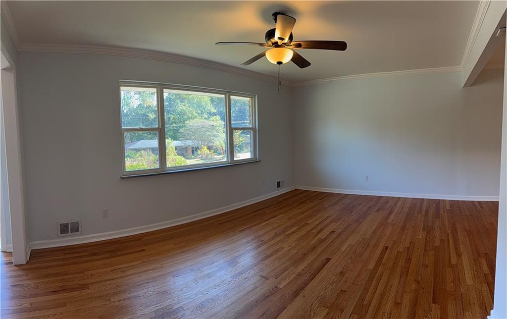 1309 Weston Drive Decatur, GA 30032 - Photo 27 of 35 a view of an empty room with wooden floor and a window