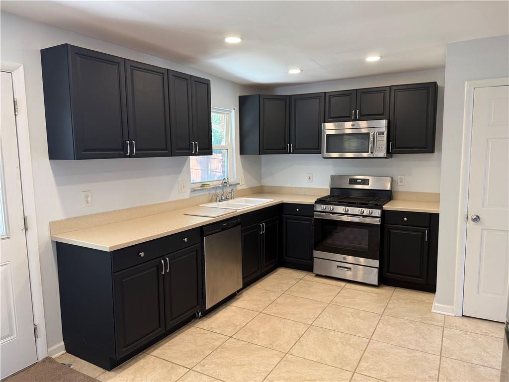 1309 Weston Drive Decatur, GA 30032 - Photo 30 of 35 a kitchen with a sink and steel appliances