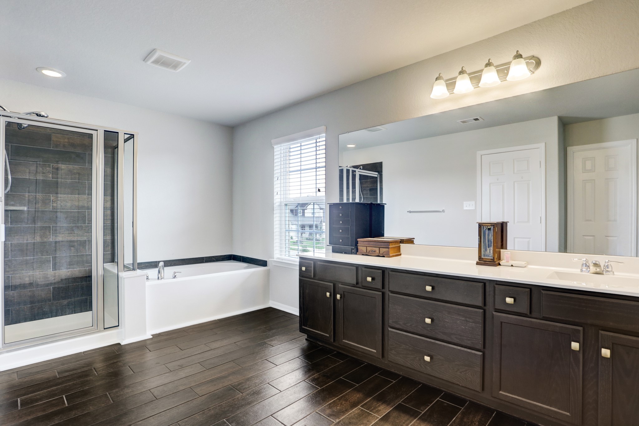5414 Rustic Ruby Drive Fulshear, TX 77423 - Photo 9 of 18 a bathroom with a tub sink double vanity and a mirror