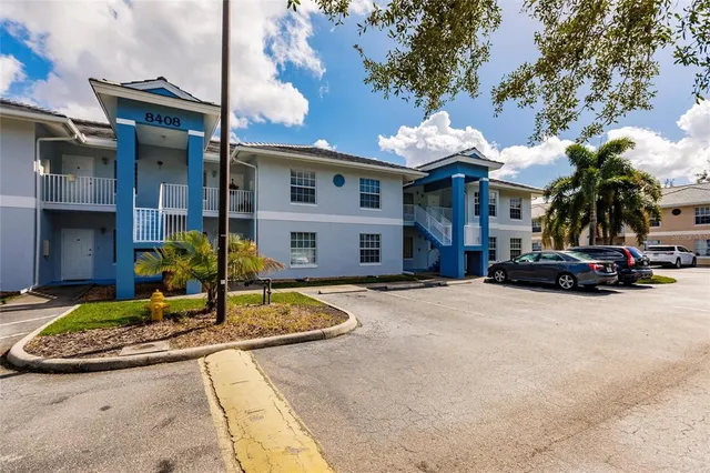 a front view of a house with a yard garden and outdoor seating