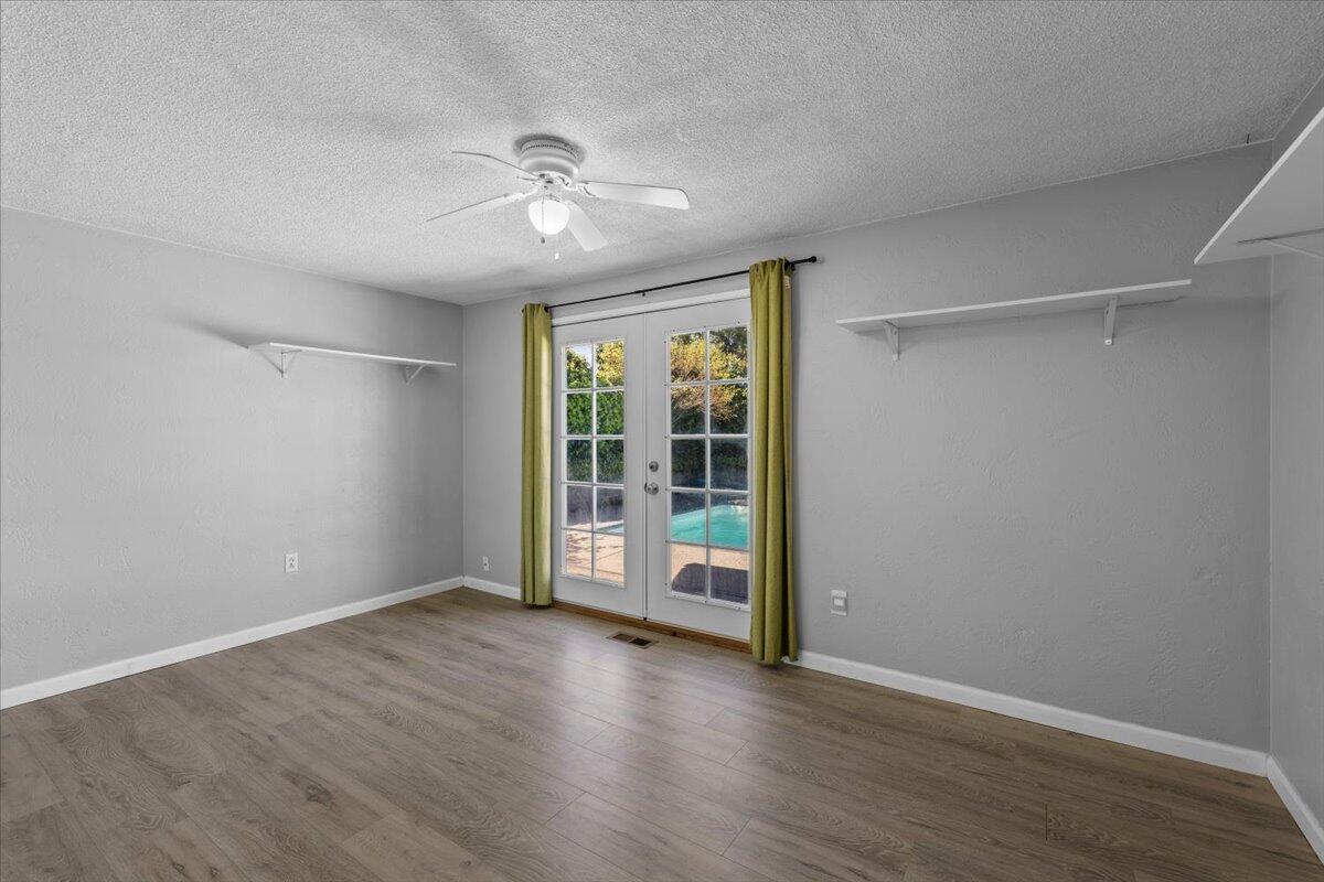 113 Houston Road Phoenix, OR 97535 - Photo 19 of 29 a view of an empty room with a window and wooden floor