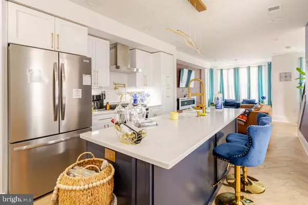 a kitchen with stainless steel appliances granite countertop a sink a refrigerator and a refrigerator