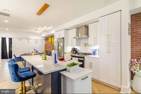 a kitchen with a sink a stove and chairs