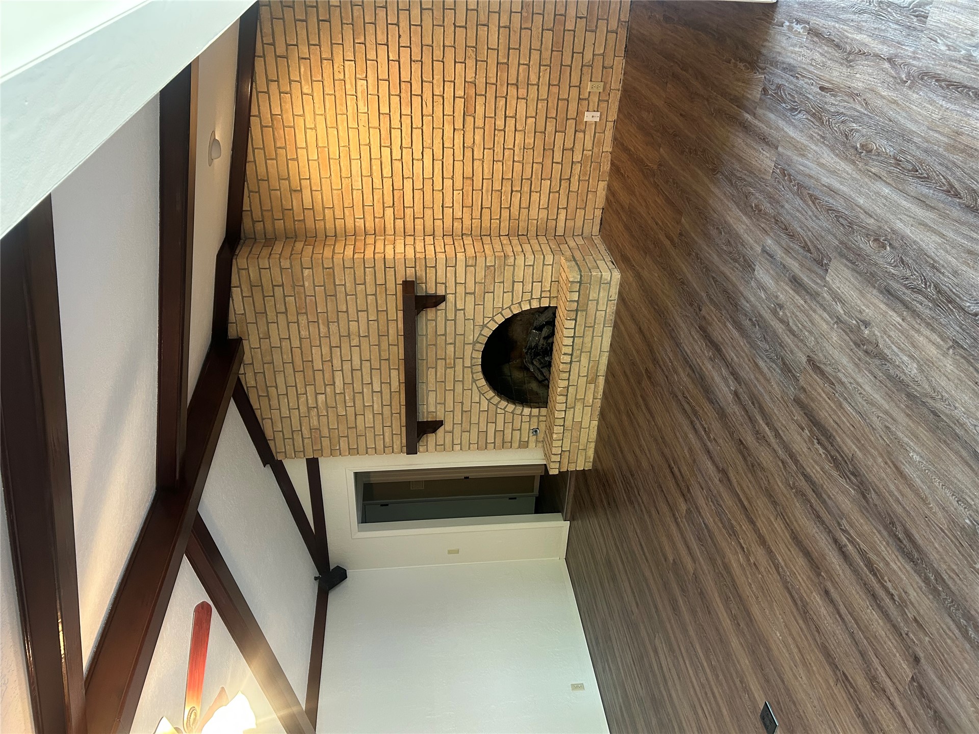 2913 Springdale Lane Duncan, OK 73533 - Photo 20 of 32 Vaulted ceiling with exposed wood beams, wood-finish flooring, and a brick fireplace with a wood mantel
