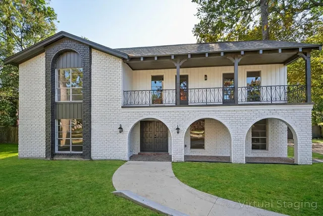 a front view of a house with garden
