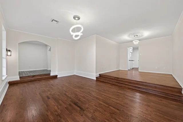 a living room with furniture wooden floor and a large window