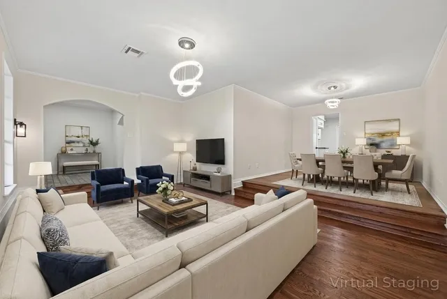 a living room with furniture kitchen view and a table