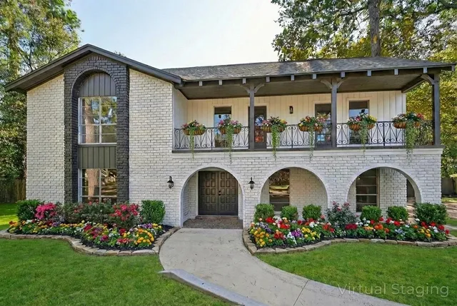 a front view of a house with a garden