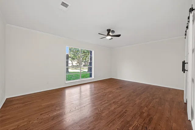 a spacious bedroom with a bed a couch and a window