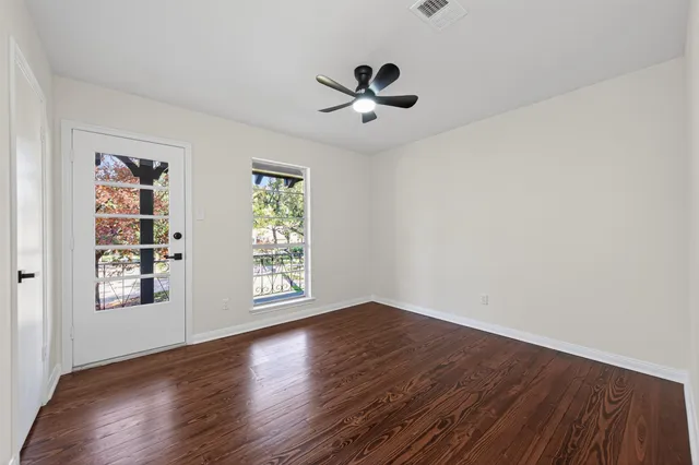 a bedroom with a bed a bookshelf and a window