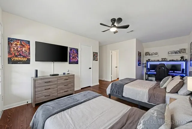 a bedroom with two bed and a chandelier