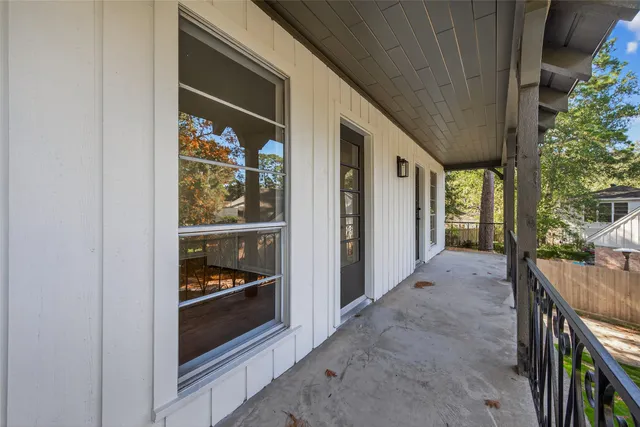 a balcony with furniture and potted plants