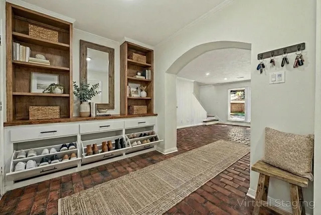 a living room with stainless steel appliances granite countertop furniture and a rug