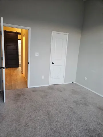 a view of an empty room with closet and a closet