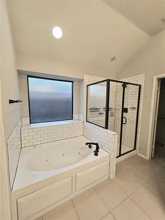a bathroom with a bathtub and a shower