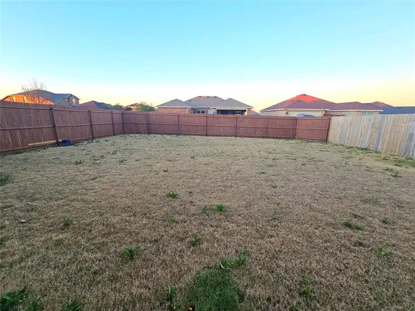 a view of an outdoor space and wooden fence