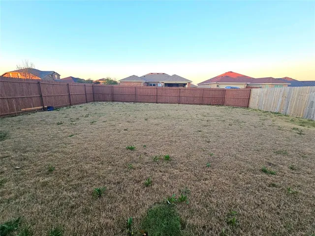 a view of an outdoor space and wooden fence