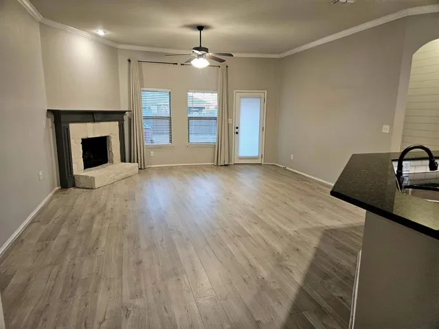 wooden floor fireplace and natural light in room
