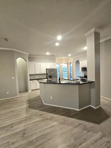 a view of kitchen with refrigerator sink and stove