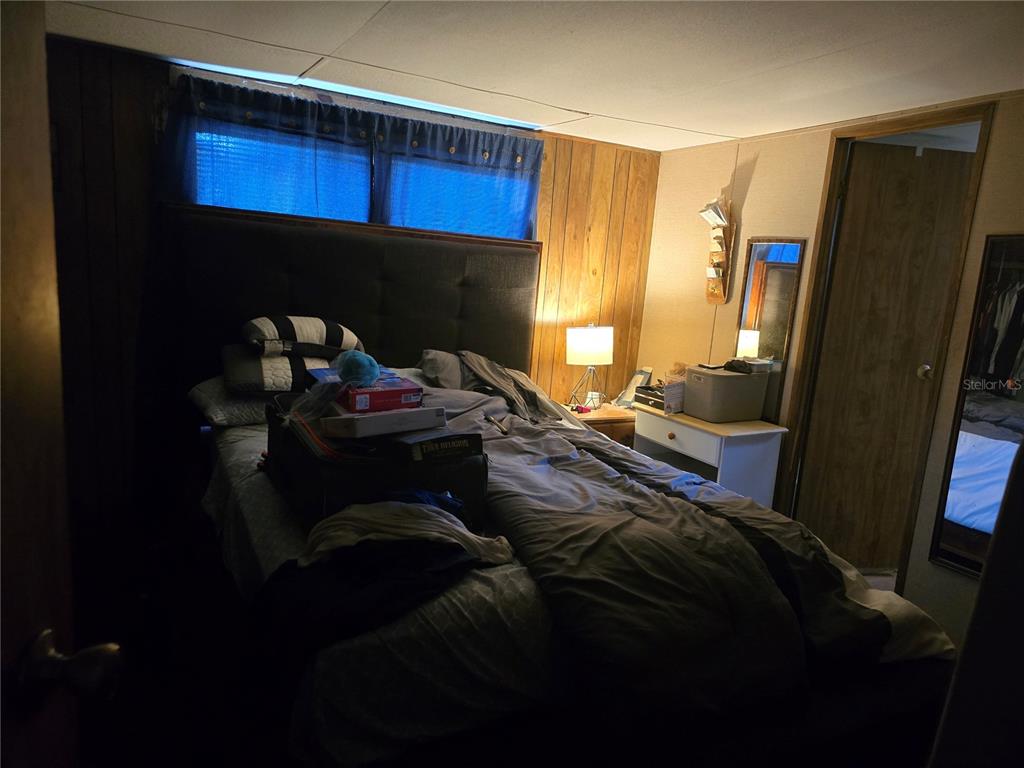 513 Smith Road Polk City, FL 33868 - Photo 14 of 33 a bed sitting in a bedroom next to a window