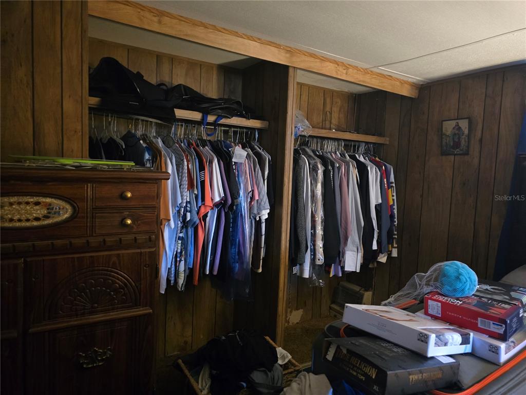 513 Smith Road Polk City, FL 33868 - Photo 18 of 33 a view of walk in closet with clothes and shoes