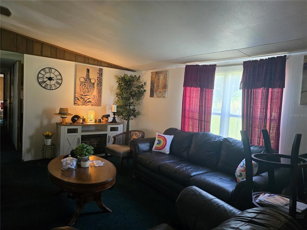 513 Smith Road Polk City, FL 33868 - Photo 8 of 33 a living room with furniture and a large window