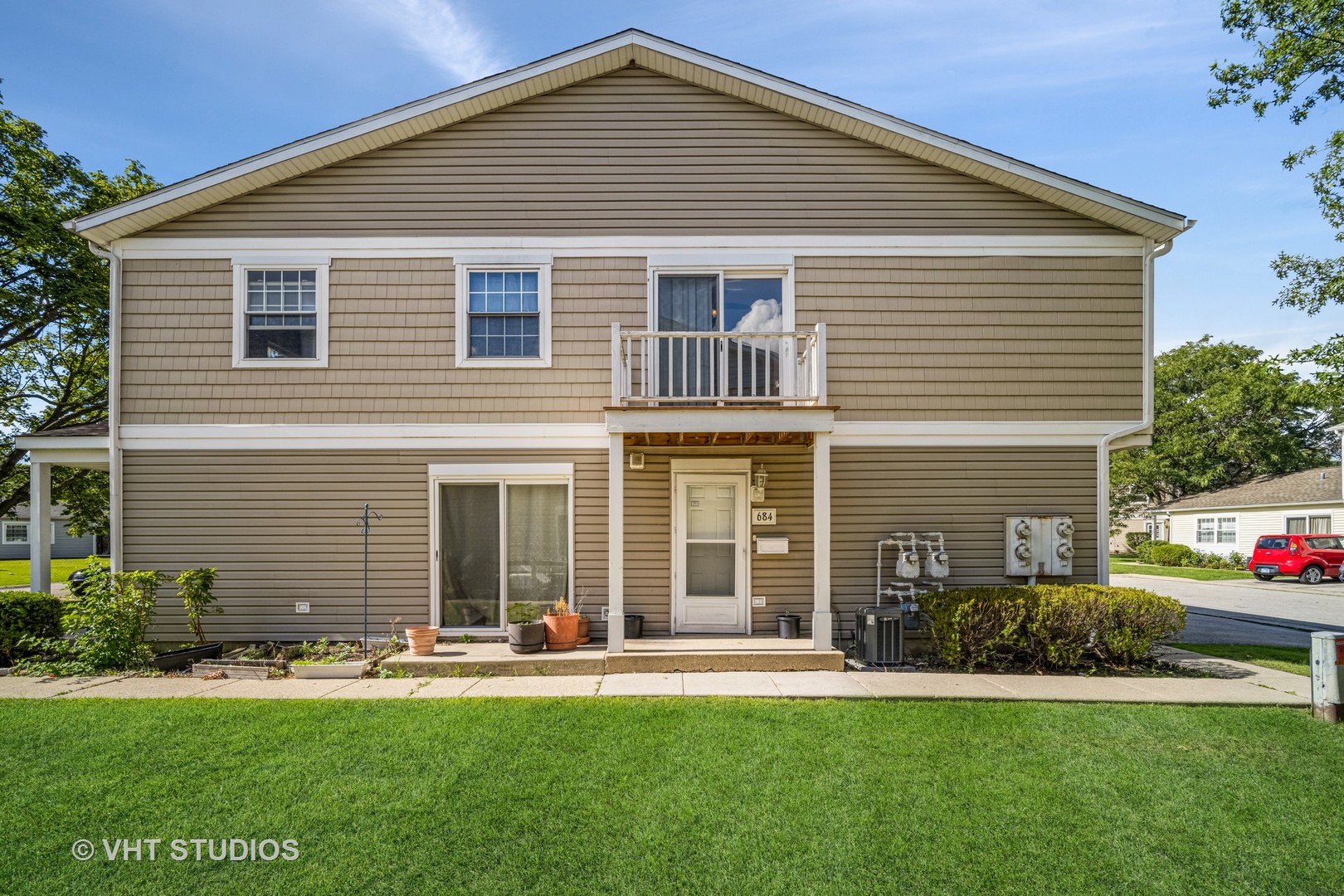 684 Cleo Court, Unit 684 Wheeling, IL 60090 - Photo 1 of 13 a front view of a house with a yard