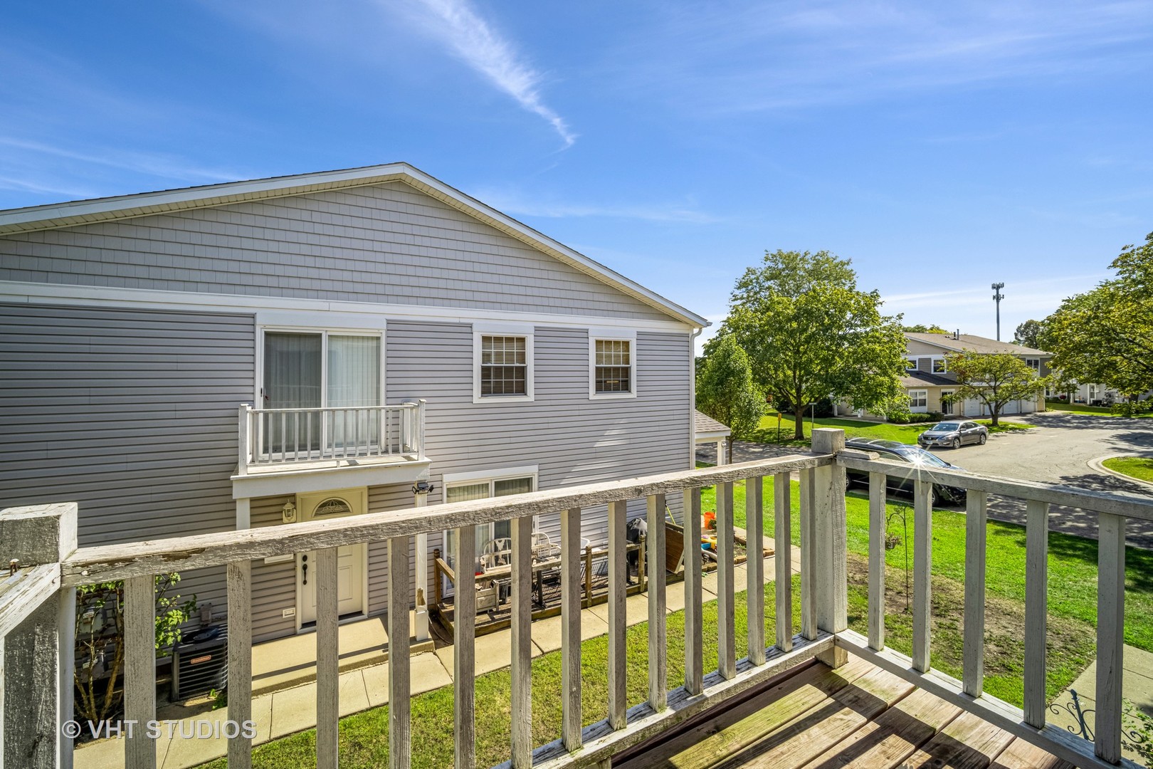 684 Cleo Court, Unit 684 Wheeling, IL 60090 - Photo 12 of 13 a view of a house with a deck and a yard