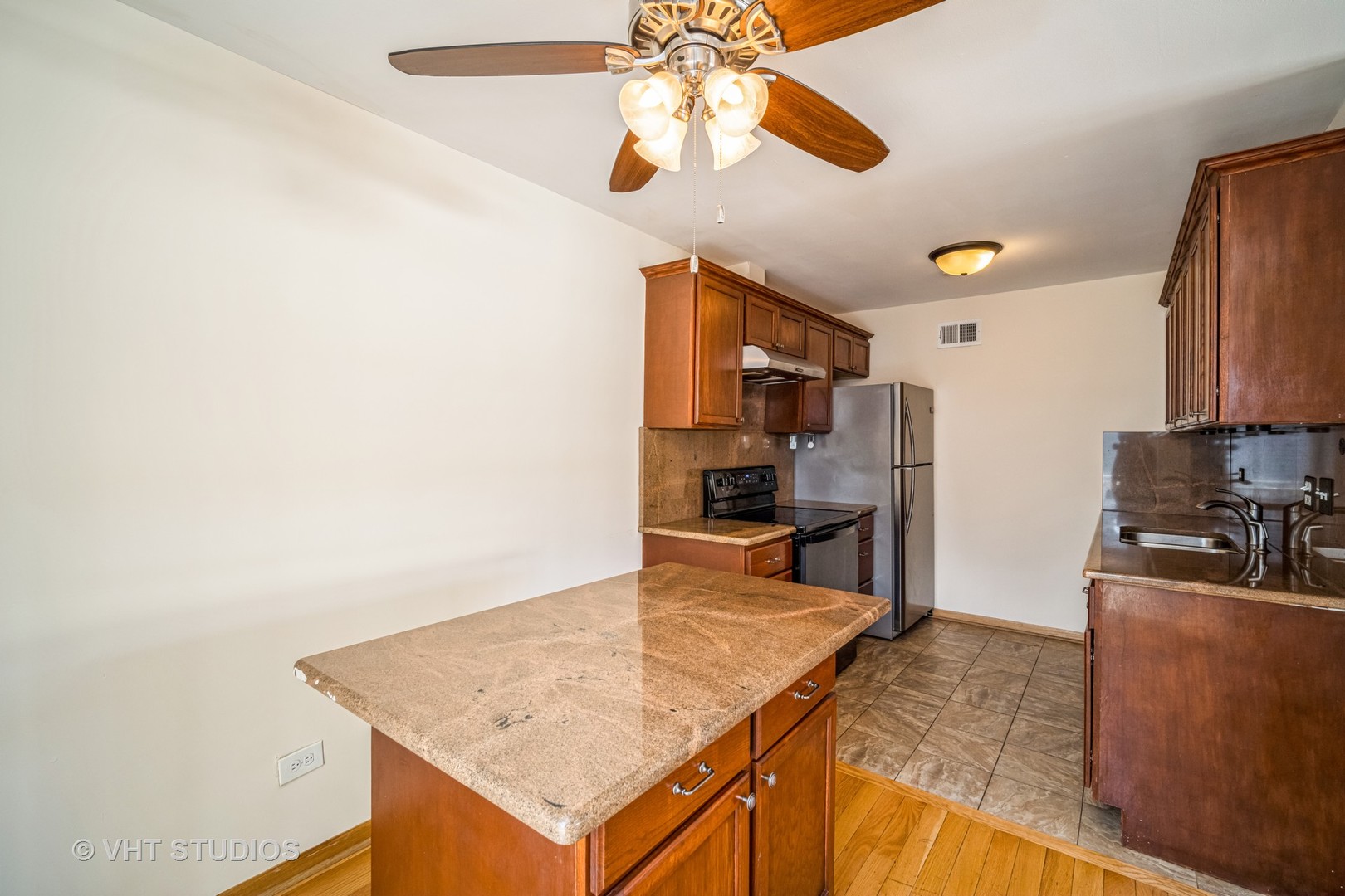 684 Cleo Court, Unit 684 Wheeling, IL 60090 - Photo 5 of 13 a kitchen with stainless steel appliances granite countertop a sink a stove top oven a chimney and a refrigerator