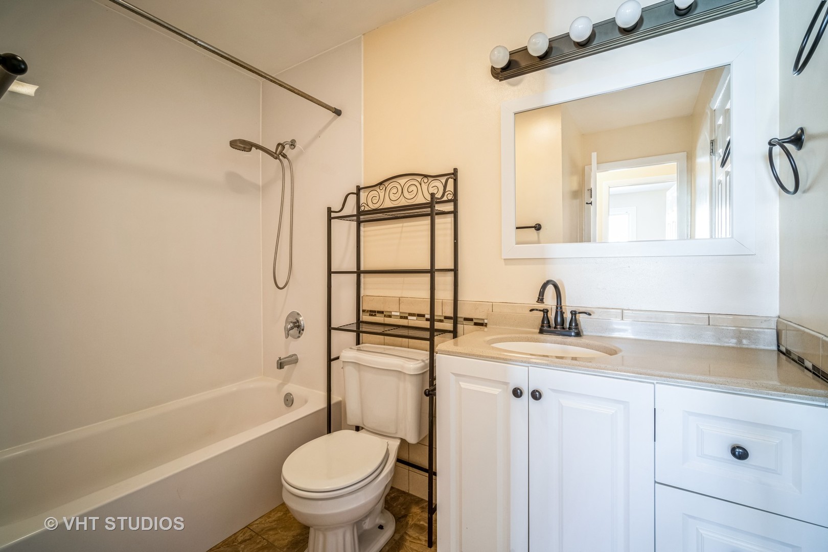 684 Cleo Court, Unit 684 Wheeling, IL 60090 - Photo 8 of 13 a bathroom with a granite countertop sink toilet and shower