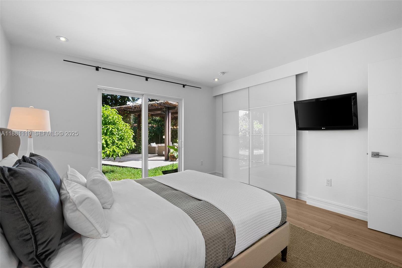 575 Bay Point Road Miami, FL 33137 - Photo 14 of 87 a bedroom with a bed and a television