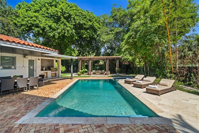 a view of a house with swimming pool and sitting area