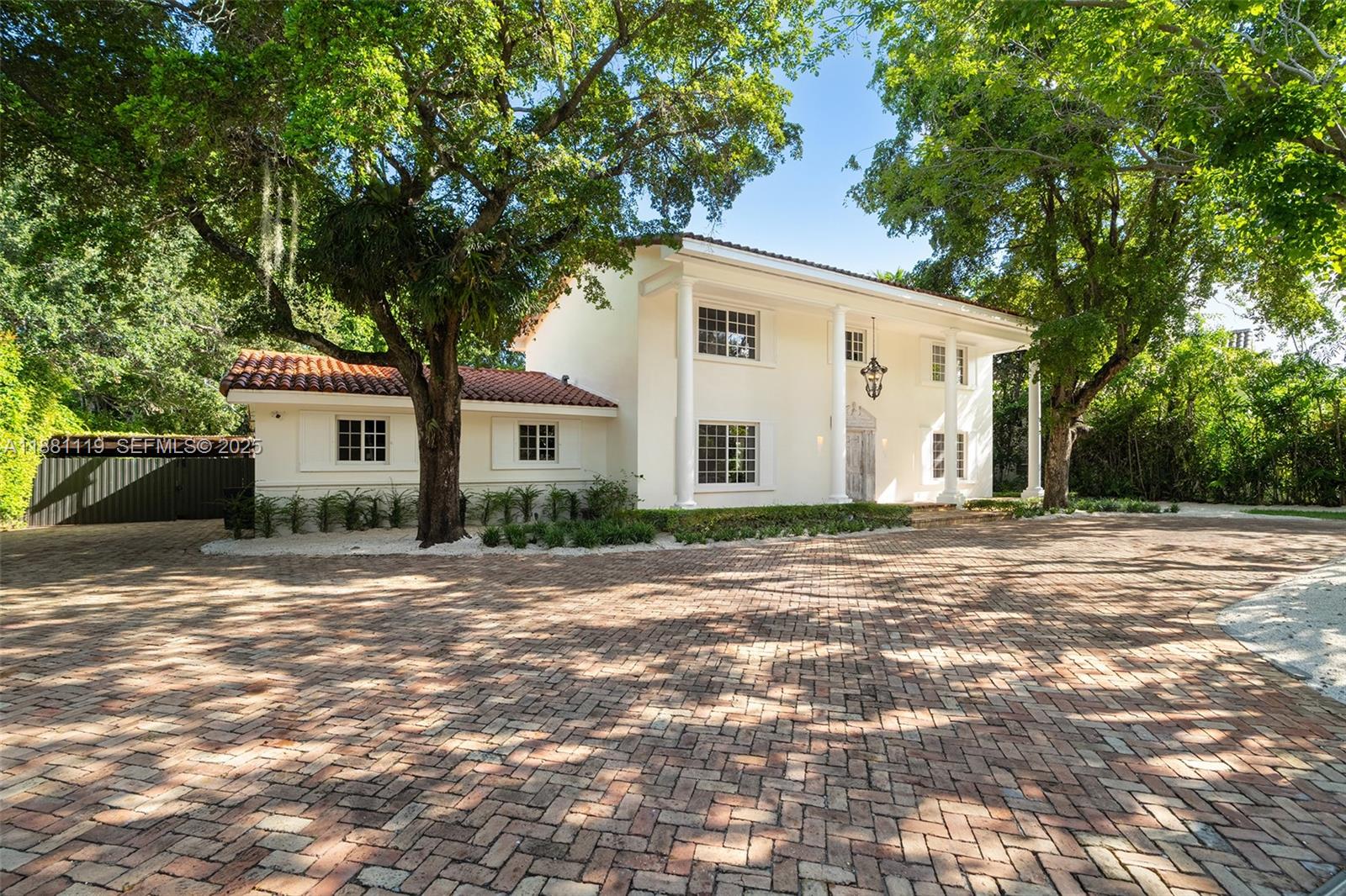 575 Bay Point Road Miami, FL 33137 - Photo 22 of 87 a view of a house with a tree in front of it